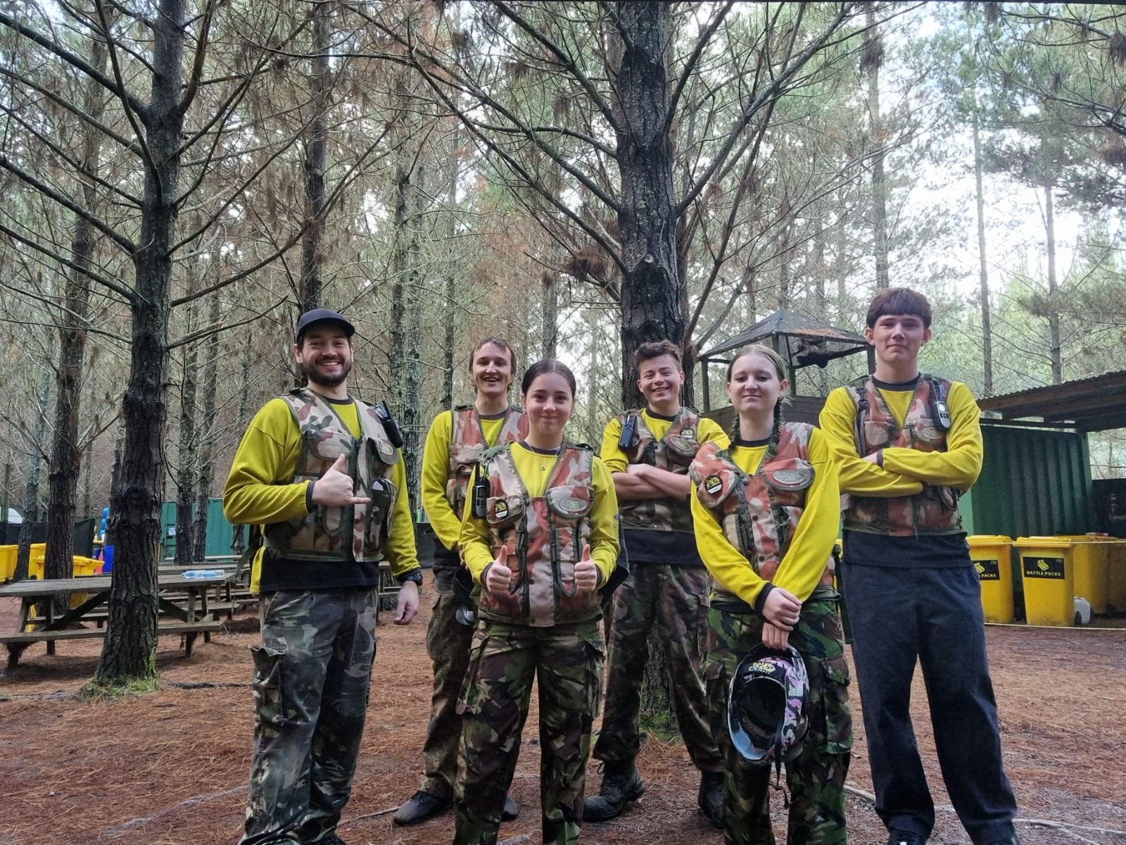 Six Delta Force marshals gathered together in woodland surroundings